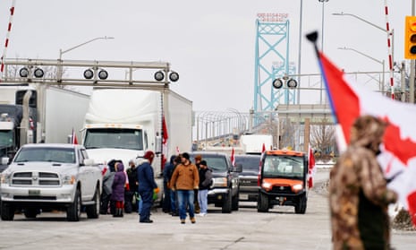 Supporters of the so-called ‘Freedom Convoy’ against the Covid-19 vaccine mandate block traffic in the Canada-bound lanes of the Ambassador Bridge border crossing, in Windsor, Ontario.
