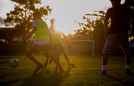 Teenage asylum seekers play football in Granville Park, in western Sydney.