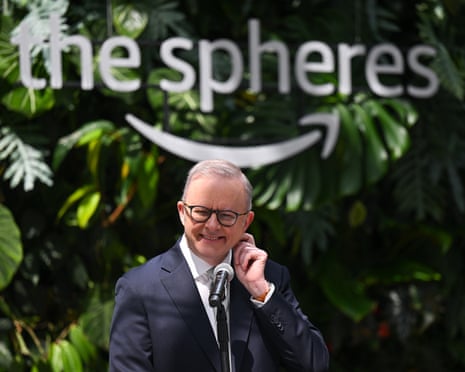 Anthony Albanese smiles with the Amazon Spheres logo behind him