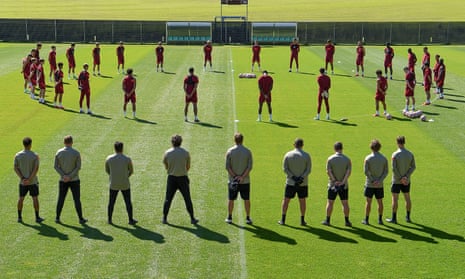 The Liverpool team and backroom staff observing a 97-second silence for Andrew Devine.