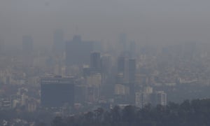 Buildings stand shrouded in smog in Mexico City.