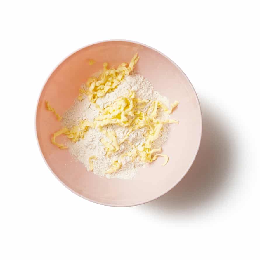 Put the flour in a large bowl or food processor and grate in the butter. Whizz, or rub this in with your fingertips until well combined.