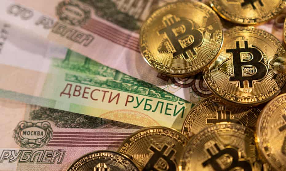 An illustration of Russian ruble banknotes and representations of the cryptocurrency bitcoin.