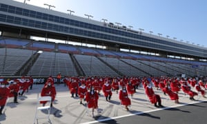 Ponder High School graduates sit in chairs separated 6ft apart in Fort Worth, Texas Tuesday.