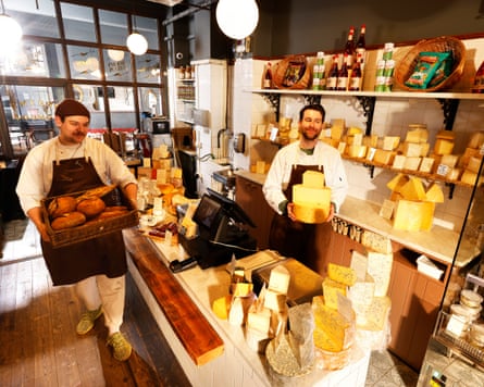 George Jones (hat) and Nick Kelleher (holding cheese) at I J Mellis, the Edinburgh cheesemongers in Morningside, Edinburgh, Scotland