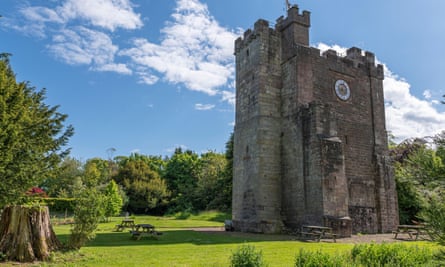 Preston Tower, the fourteenth-century pele tower, surrounded by trees on a sunny day.