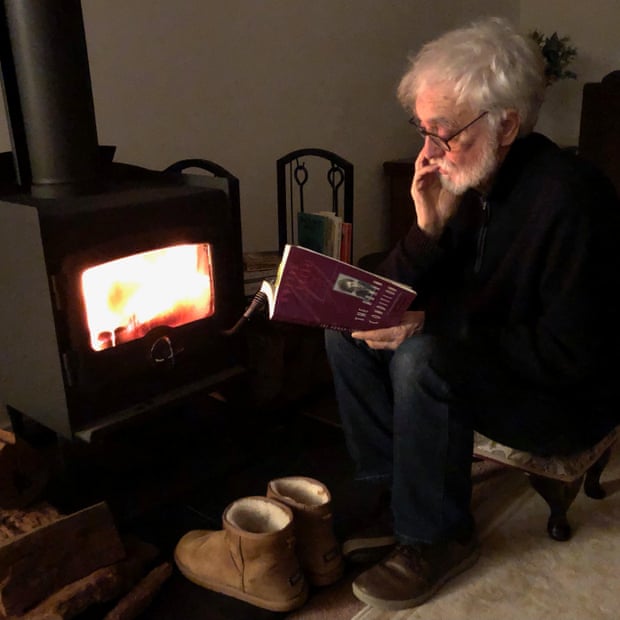 Dennis reads by the fire