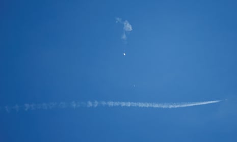 A jet flies by the suspected Chinese spy balloon after shooting it down off the coast close to Surfside Beach, South Carolina, US.