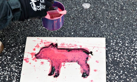 Greenpeace activists paint dead piglets outside the Environment and Food Ministry to call for a reduction in Denmark’s extensive meat production. 