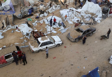 Palestinians gather at the site of a tent camp that was struck by an Israeli airstrike on Friday, in Gaza City, June 28, 2025.
