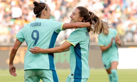 Clare Wheeler is congratulated by Caitlin Foord after scoring Australia’s eighth goal.