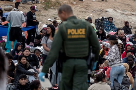 People wait in the no man's land between the US and Mexico, near San Diego, California, on 12 May.