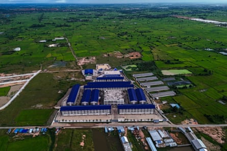 A drone view of a compound in a green landscape