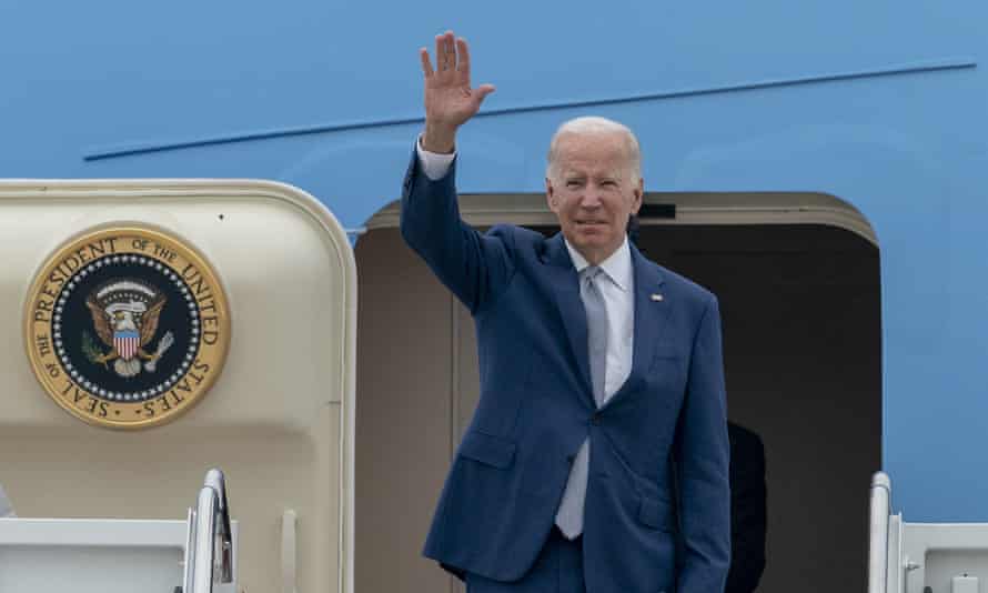 Joe Biden waves his hand as he boards Air Force One at Air Force Base Andrews in Maryland on June 14th.