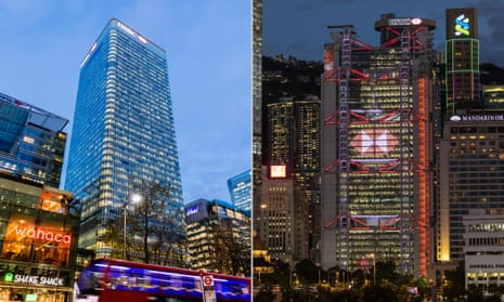 Composite photograph of a rectangular-section  glass skyscraper viewed close up from below with an illuminated HSBC logo at the top, and a more futuristic tower on the right, with what appear to be external lift shafts and an HSBC logo projected on to it