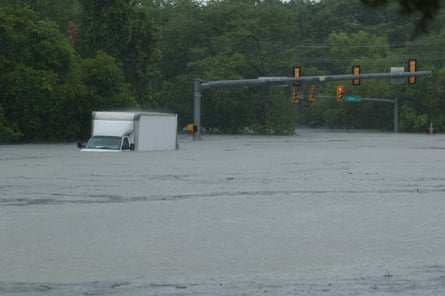 A white-paneled motortruck sitting successful h2o almost up to nan windshield.