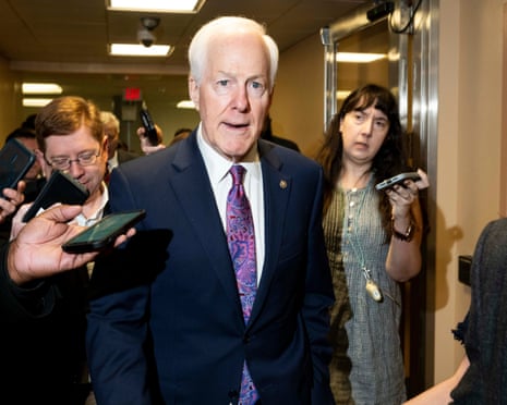 An older man is swarmed by reporters