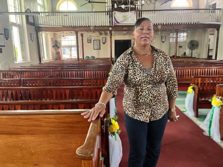 woman stands next to pews