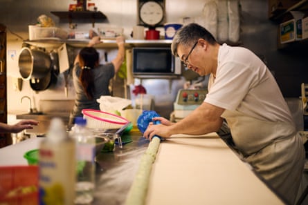 Owner and baker Shaun Du preparing vegetarian sausage rolls.