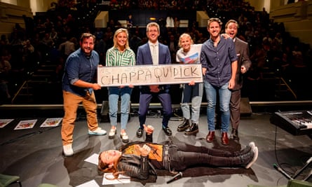 A piece of the temporary fence has been showcased at comedy show A Rational Fear before it is sold via an online auction. From left: Dan Ilic, Simone Ball Santamaria, Lewis Hobba, Grace Tame, Mike Santamaria, Andrew McClelland and Nats What I Reckon (front)