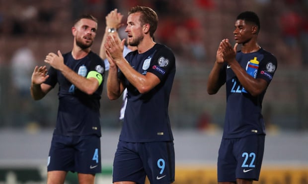 Harry Kane, Jordan Henderson and Marcus Rashford of England applaud the travelling fans after the game between Malta and England.