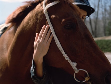 Woman embracing a brown horse