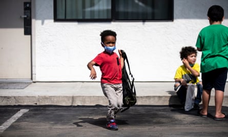 A boy tries on a new backpack he received during a back to school resource fair amid the coronavirus pandemic in Sylmar, north of Los Angeles.