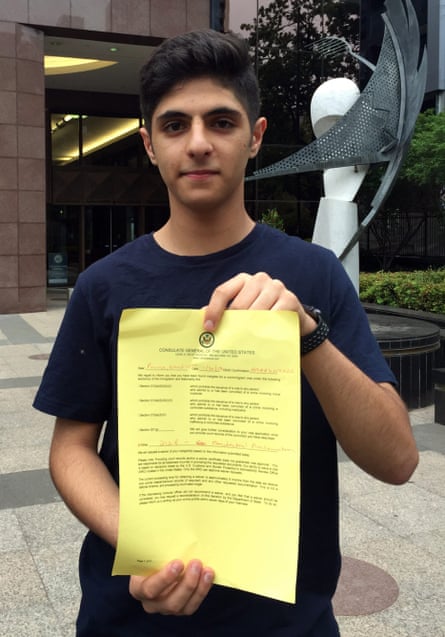 Australian schoolboy Pouya Ghadirian shows the document declining his visa request outside the US consulate in Melbourne on Monday.
