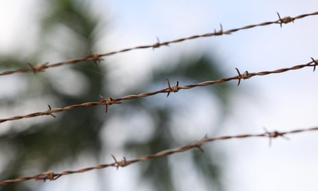 youth crime case studies australia barbed wire with palm trees in background at a youth detention centre