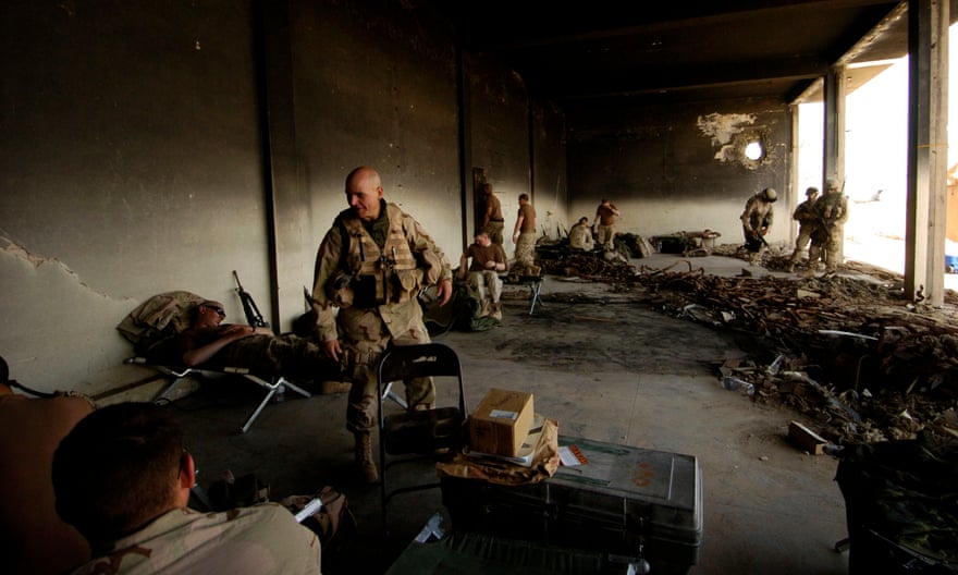 McMaster greets troops resting in an old maintenance building in Babil province, Iraq, in April 2005.