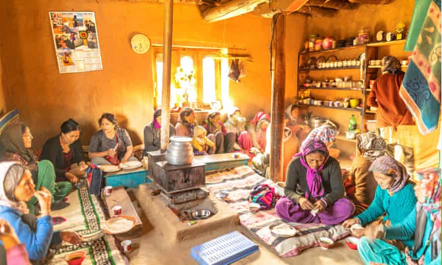 A group photo of travellers and locals 
 sat on the floor of a traditional house in India. NotOnMap aims to protect farmers and help rural villages become new tourism destinations