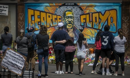 Mourners at a mural of George Floyd, close to the spot where he died in Minneapolis.