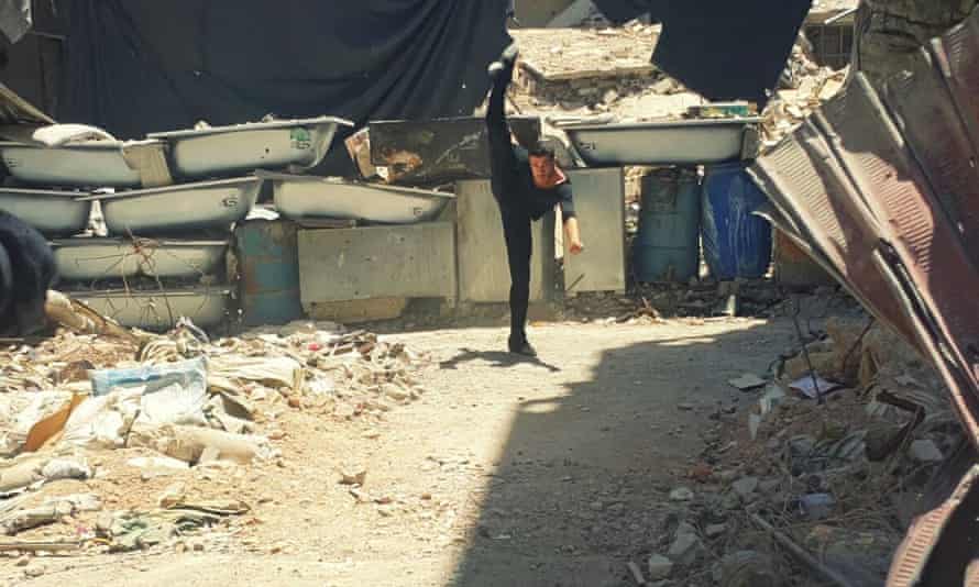 Ahmad Joudeh dances on rubble of his old refugee camp