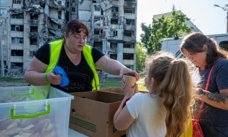 Volunteers handing out free food to people at a school in Kharkiv oblast