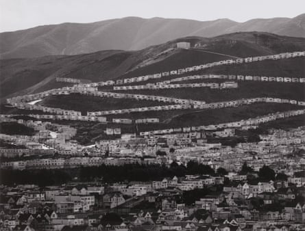 Black and white photo of houses dotting a valley