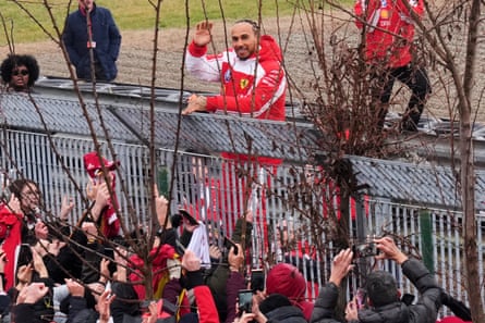 Lewis Hamilton waves to fans after his test drive of the new car