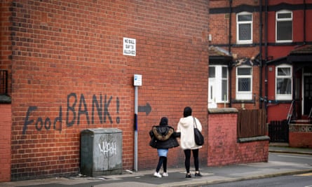 Graffiti on a wall directing people to a food bank.