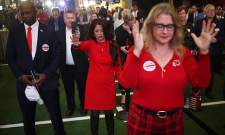 Supporters of Georgia Republican senate candidate Herschel Walker participate in a pray during an election night event at the College Football Hall of Fame.