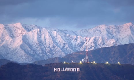 The Hollywood sign stands in front of snow-covered mountains after another winter storm