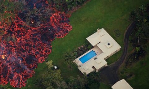 Lava consumes a home, then threatens another, near Pahoa, Hawaii, on Sunday.