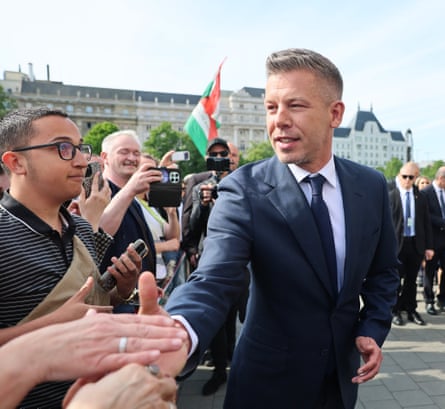 Peter Magyar shaking hands with supporters outside parliament