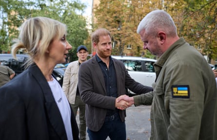 Harry with Olga Rudnieva, visiting the site of a missile strike last month, the residential Solomienka District in Kyiv where more than 20 people were killed last month.