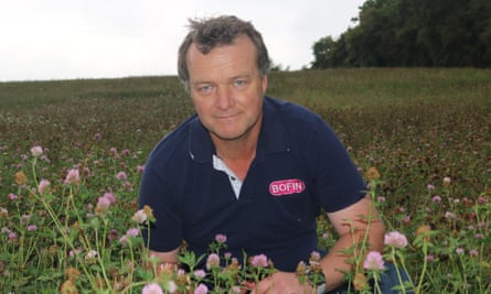 Tom Allen-Stevens sits amid a field in bloom