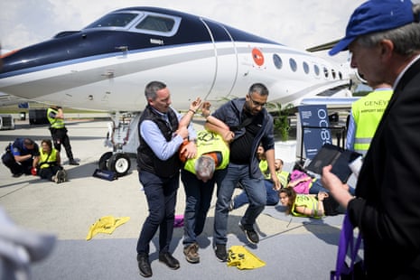 Environmental activists protest during the European Business Aviation Convention and Exhibition
