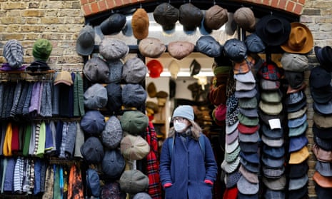 A person wearing a face covering to combat the spread of the coronavirus at a store in Camden market in London