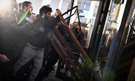 Protesters clash with riot police as they attempt to enter a courtroom in Athens