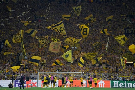 Dortmund supporters wave flags after the Champions League semi-final first leg victory over Paris Saint-Germain.