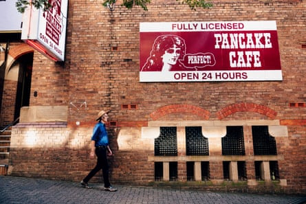Forster walks past a 1904 building, formerly a cathedral and now home to the Pancake Manor restaurant.