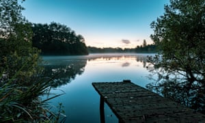 Chorlton water park with lake and jetty at sunrise.