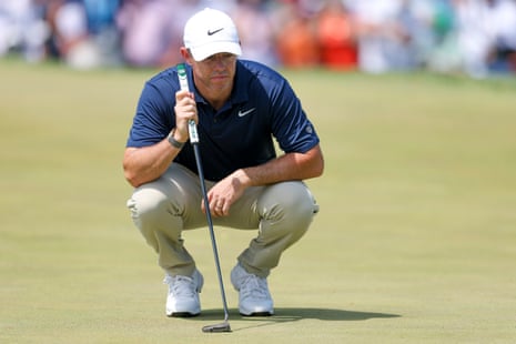 Rory McIlroy of Northern Ireland lines up a putt on the second green.